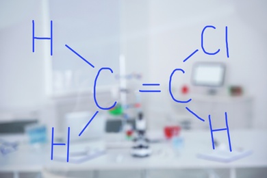 Photo of Chemical formula written by medical students on glass whiteboard in laboratory