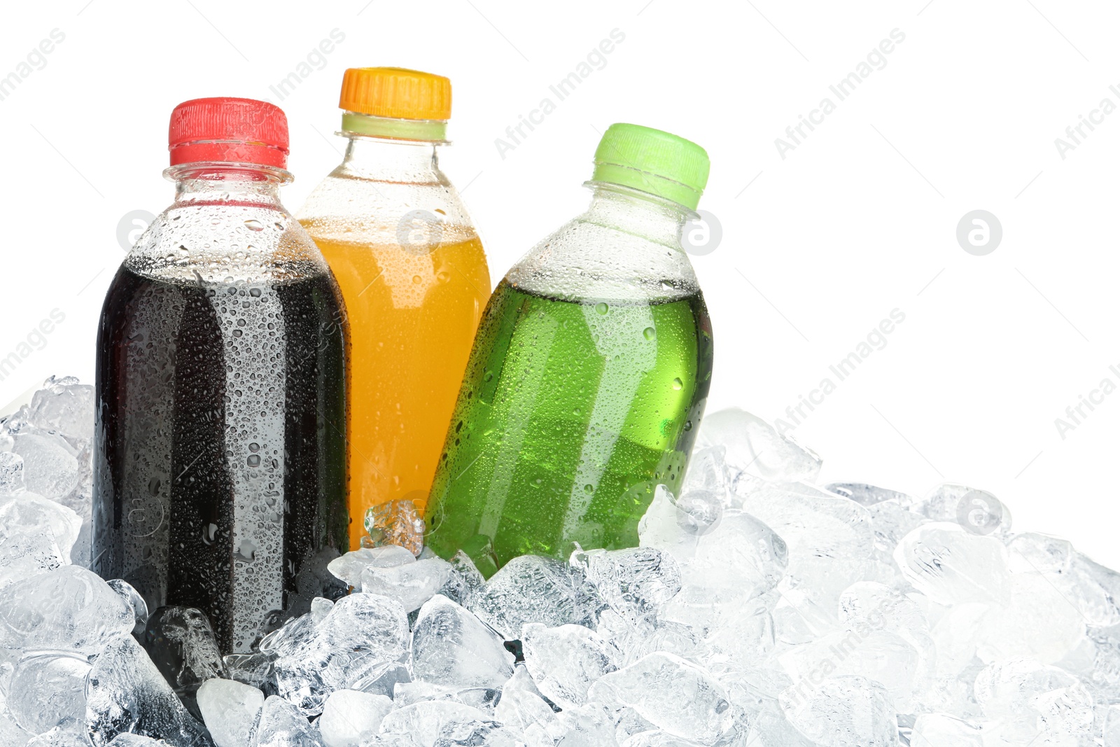 Photo of Ice cubes and different soda drinks on white background