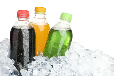 Ice cubes and different soda drinks on white background