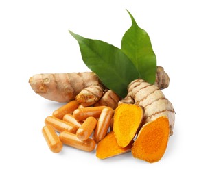 Photo of Turmeric roots, leaves and pills isolated on white
