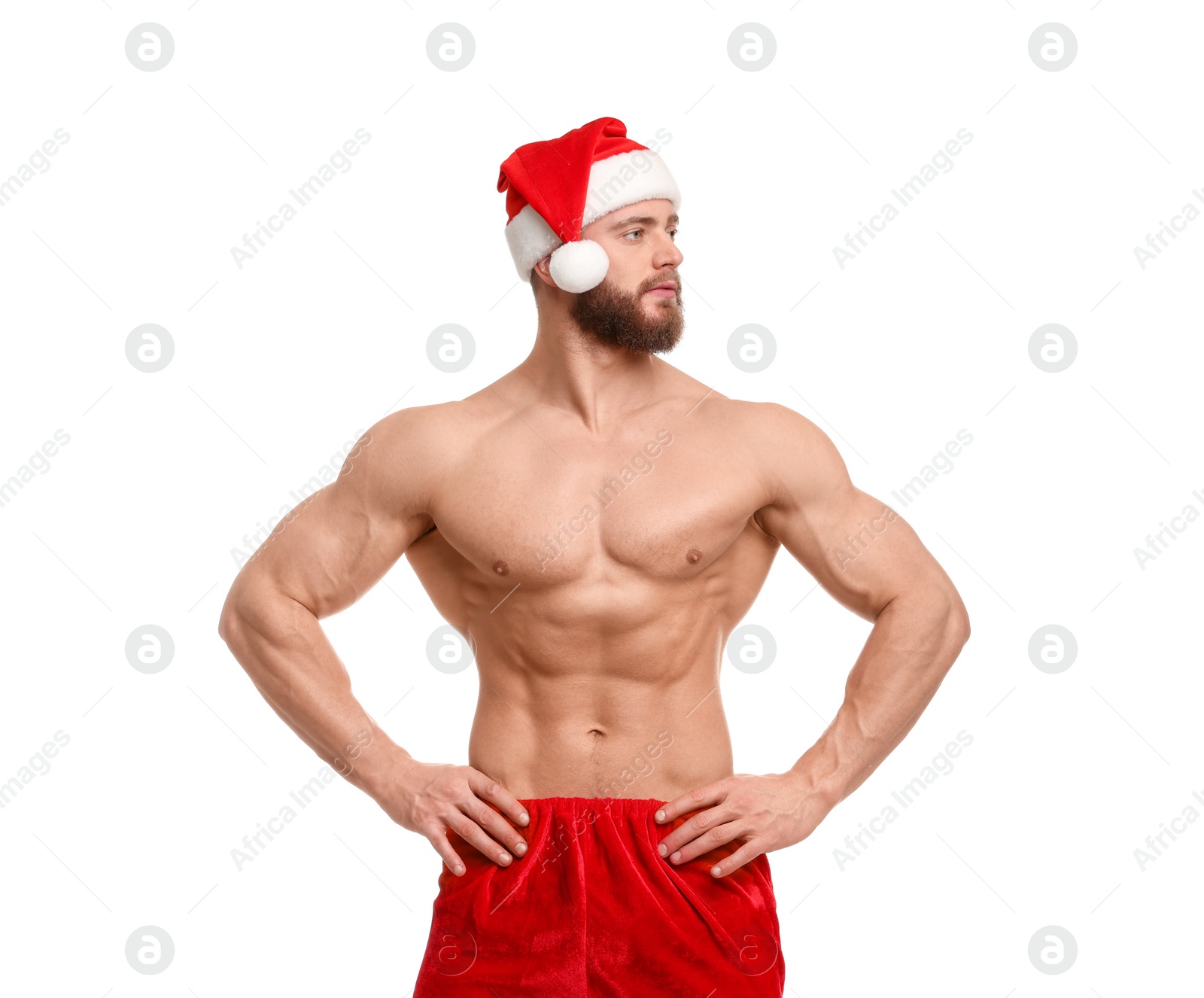 Photo of Attractive young man with muscular body in Santa hat on white background