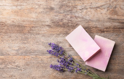 Photo of Flat lay composition with handmade soap bars, lavender and space for text on wooden background