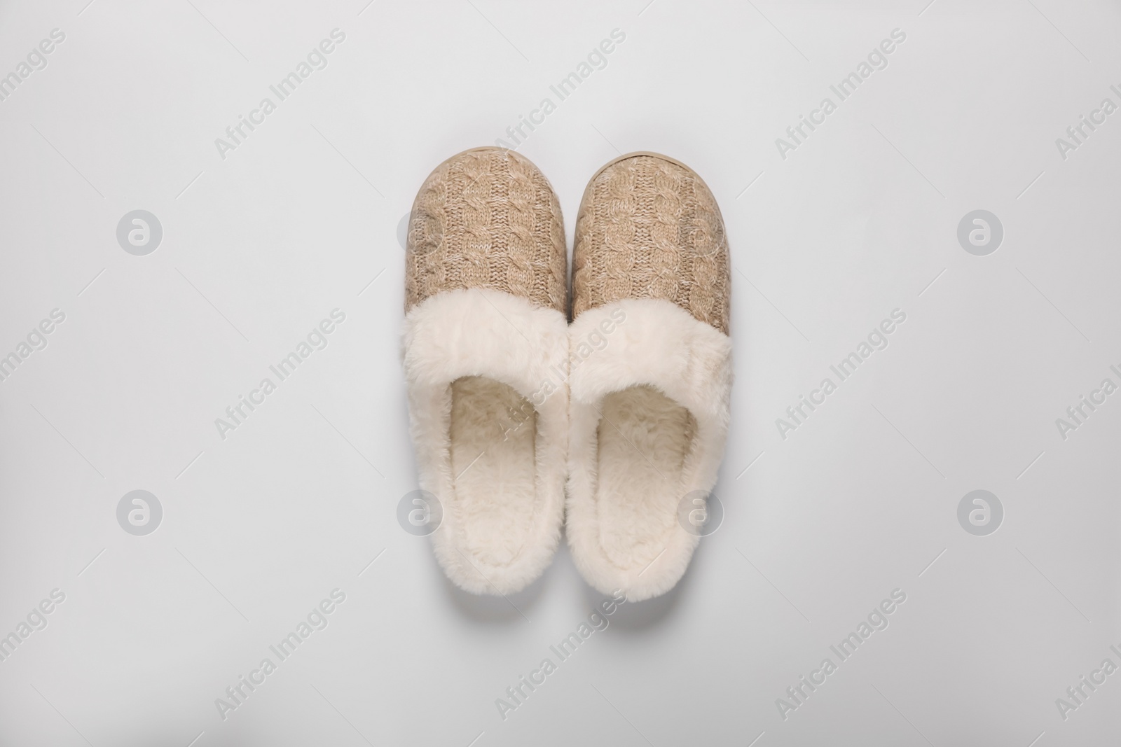 Photo of Pair of beautiful soft slippers on white background, top view