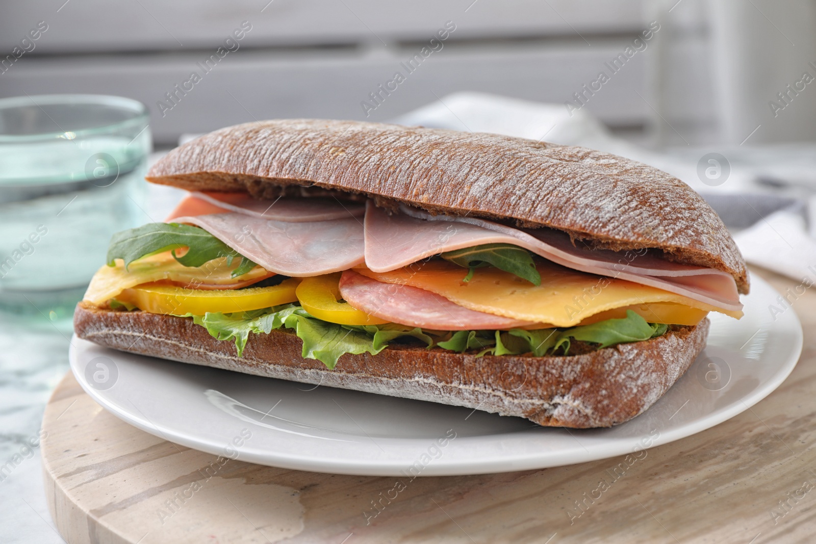 Photo of Tasty sandwich with ham on kitchen table, closeup