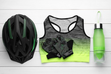 Photo of Flat lay composition with different cycling accessories on white wooden background