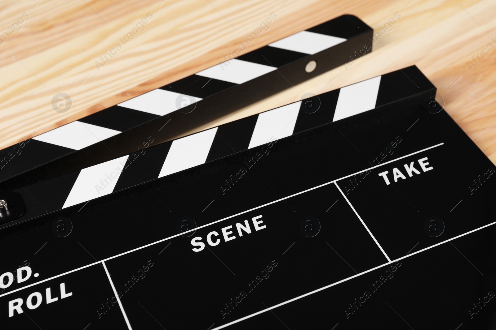 Photo of One clapperboard on wooden table, closeup view