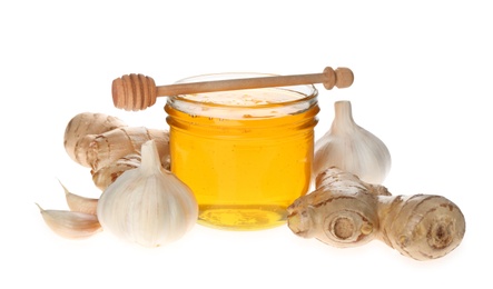 Photo of Ginger, honey and fresh garlic on white background. Natural cold remedies