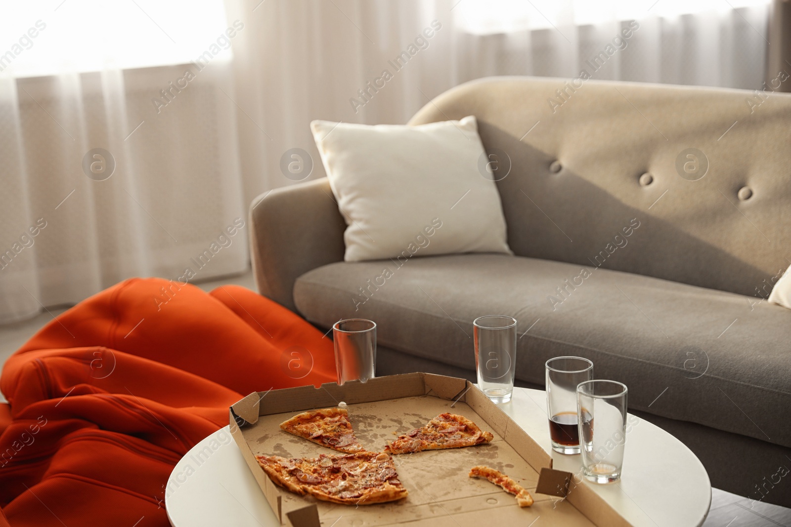 Photo of Tasty fresh pizza on light table in living room