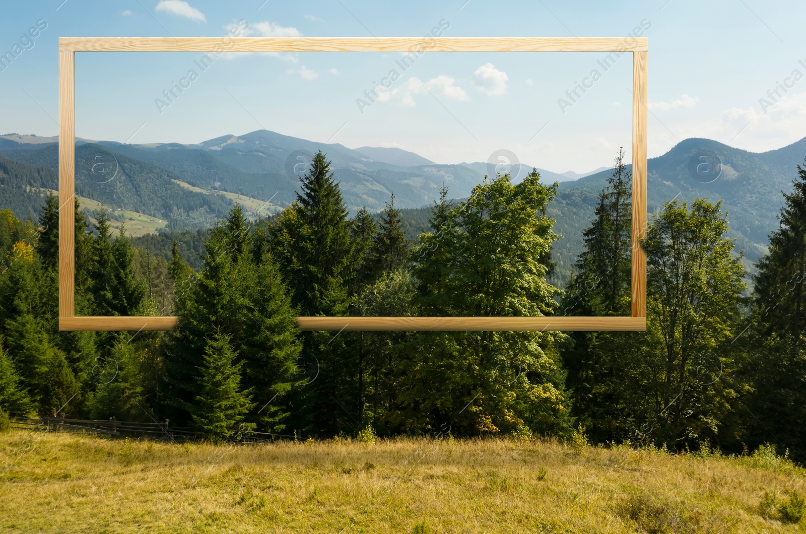 Image of Wooden frame and beautiful mountains under blue sky with clouds