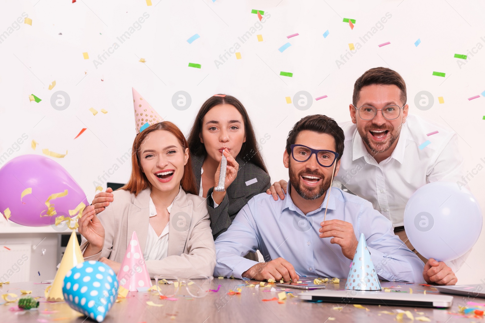 Photo of Coworkers having fun during office party indoors