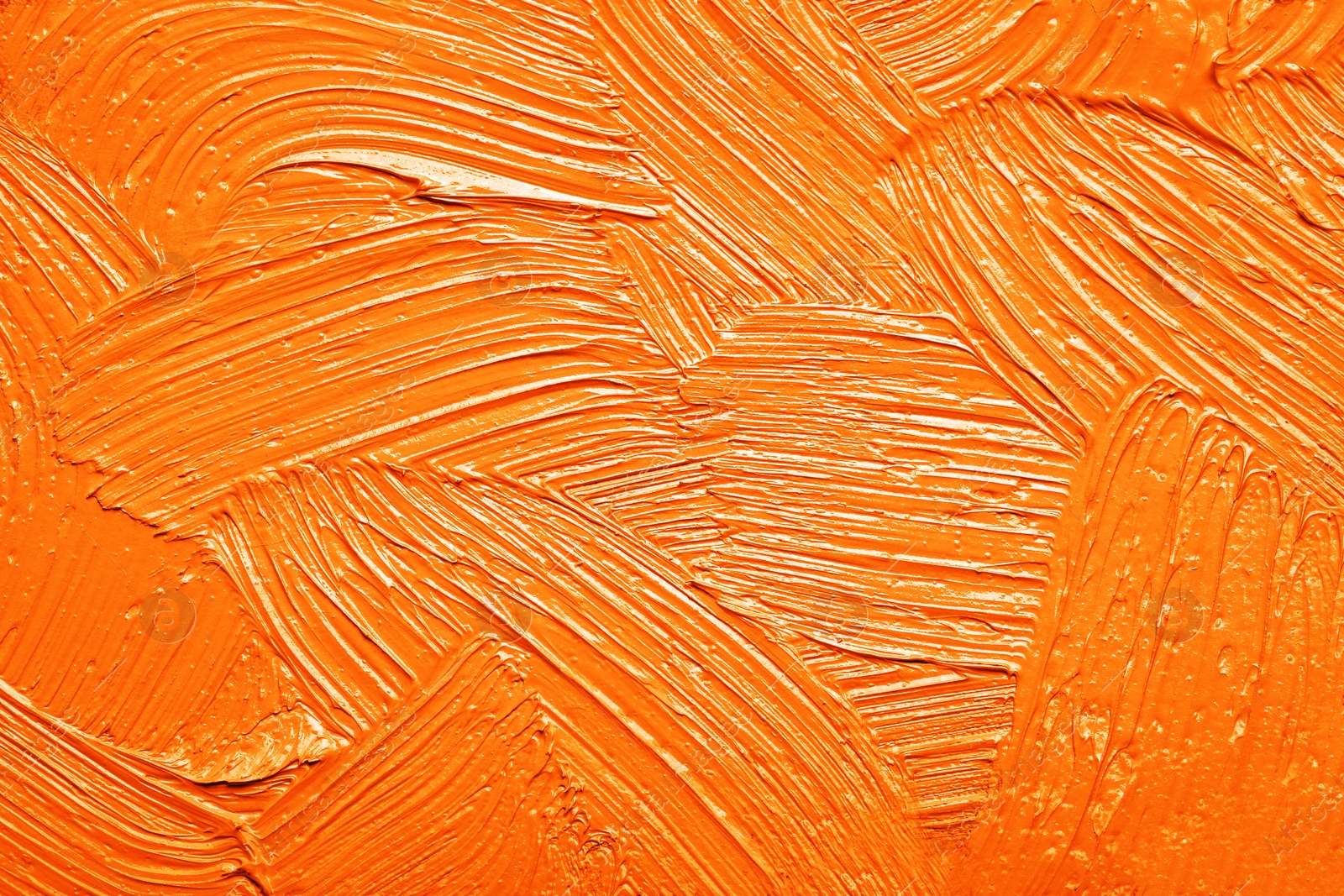 Image of Strokes of orange oil paint as background, closeup