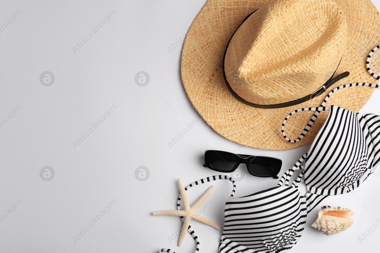 Photo of Flat lay composition with beach accessories on white background, space for text