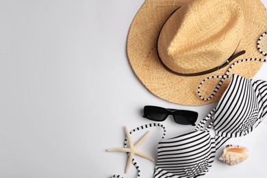 Photo of Flat lay composition with beach accessories on white background, space for text