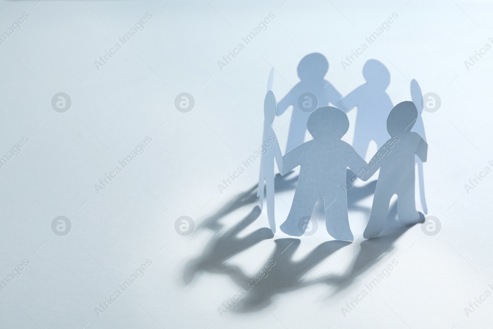 Photo of Paper people chain making circle on white background, space for text. Unity concept