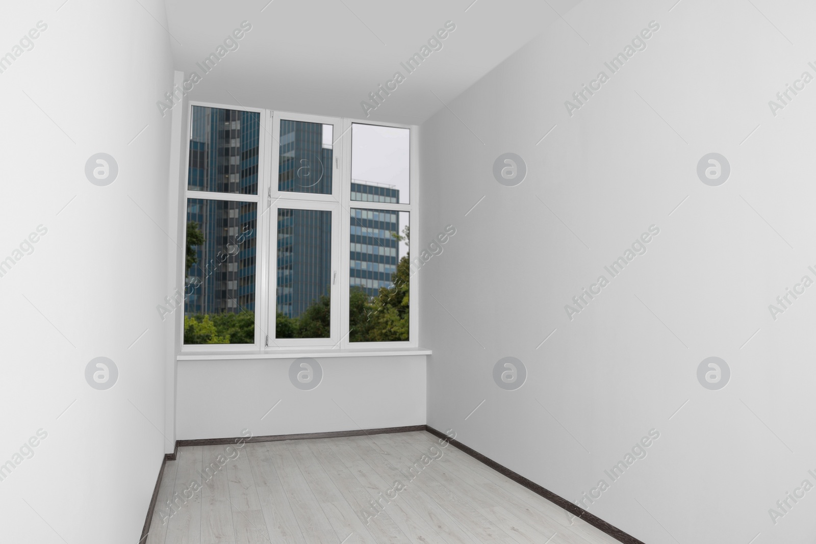 Photo of Empty office room with clean window and white walls. Interior design