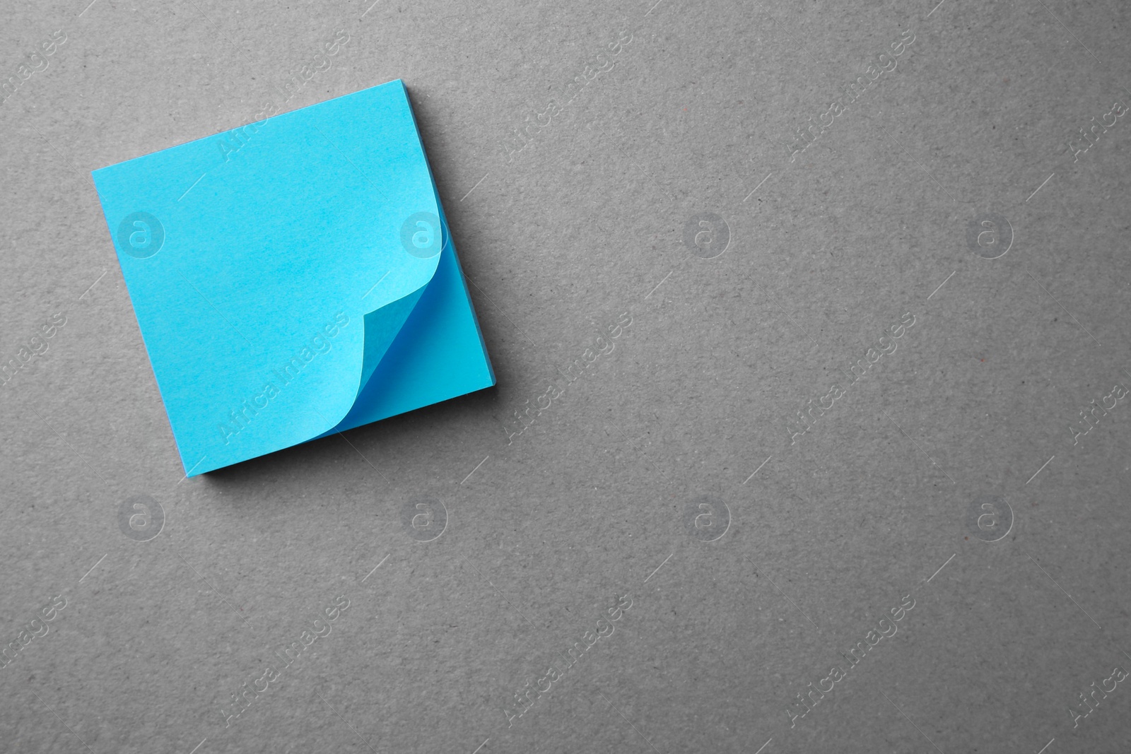 Photo of Blank paper note on gray background, top view. Space for text