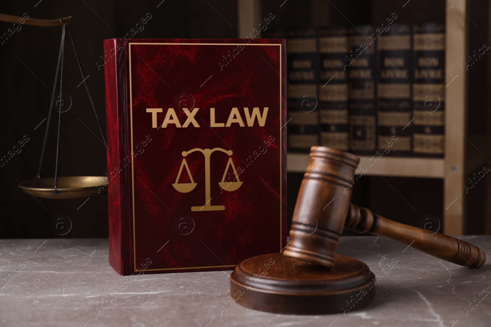 Image of Tax law book and gavel on grey marble table