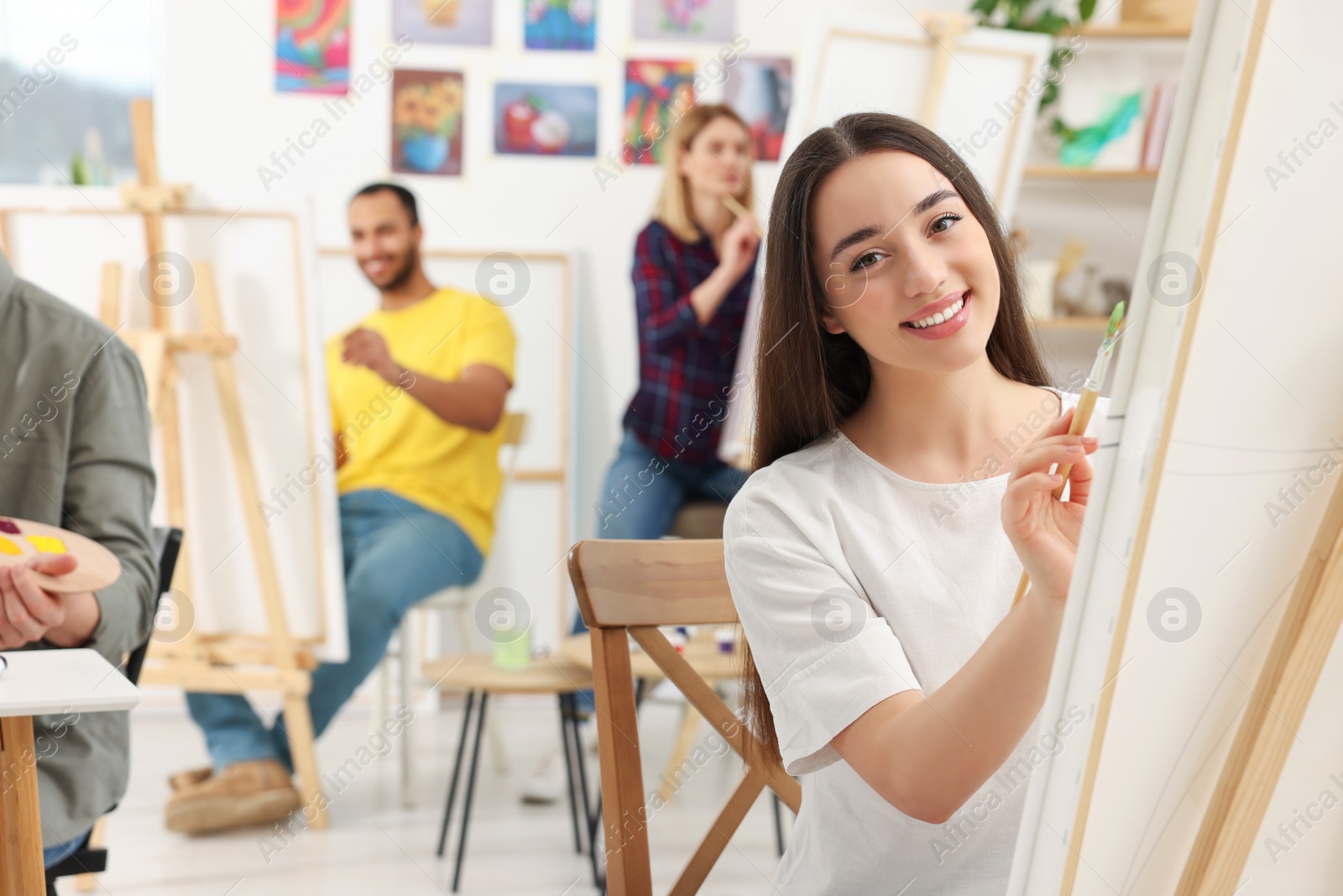 Photo of Group of students attending painting class in studio. Creative hobby