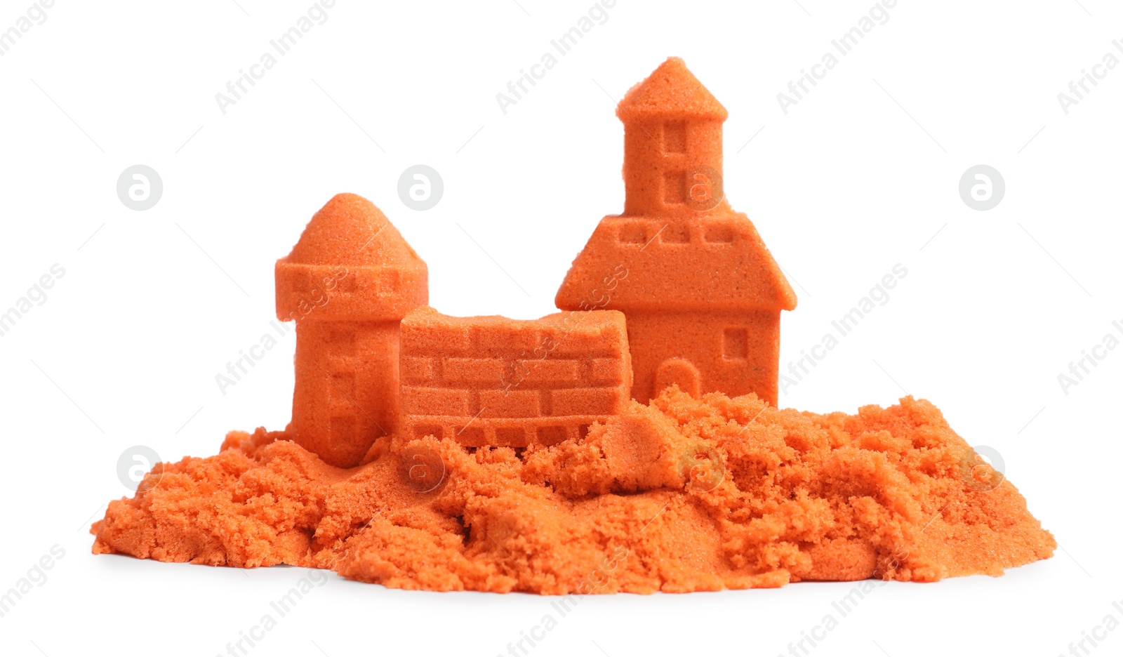 Photo of Castle figures made of orange kinetic sand isolated on white