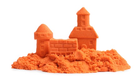 Photo of Castle figures made of orange kinetic sand isolated on white