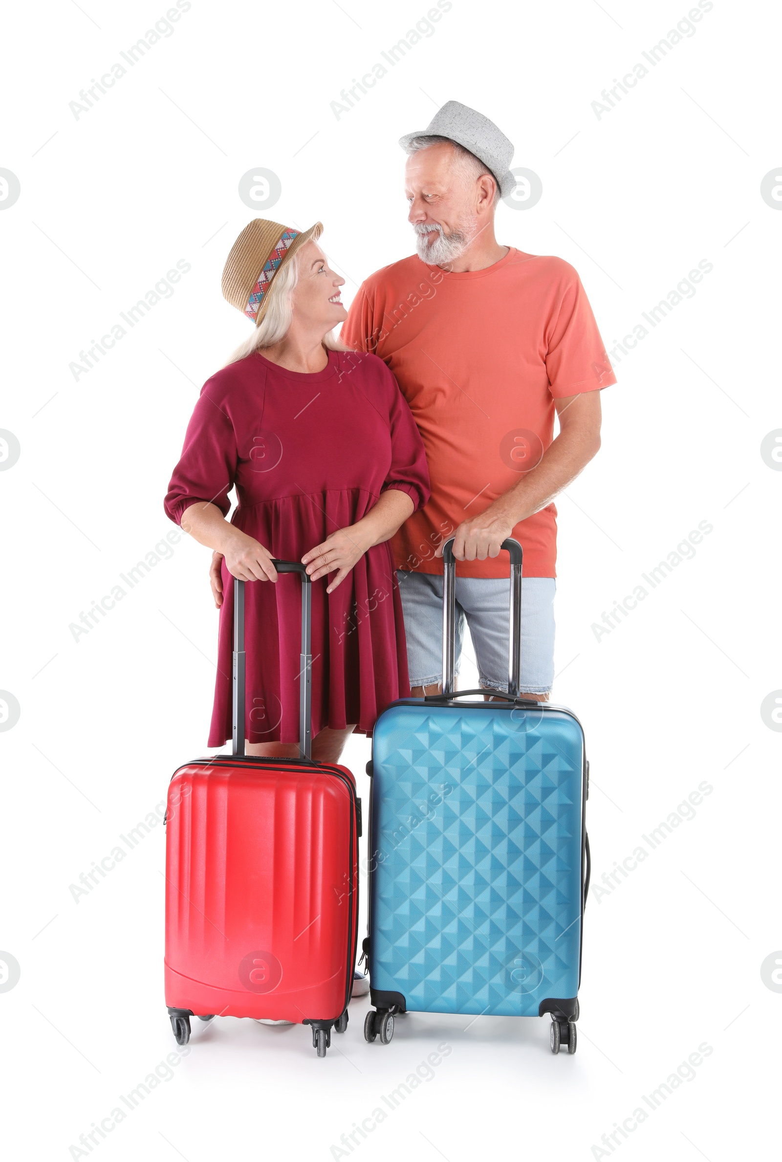 Photo of Senior couple with suitcases on white background. Vacation travel