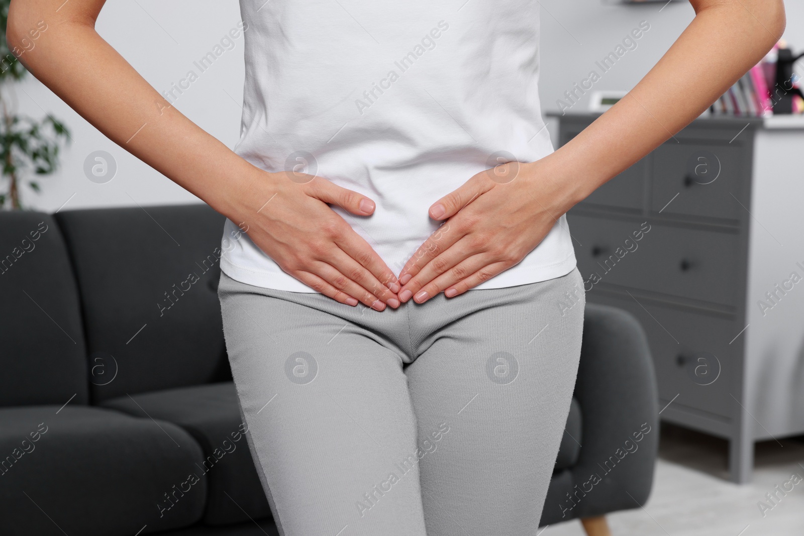 Photo of Woman suffering from cystitis at home, closeup