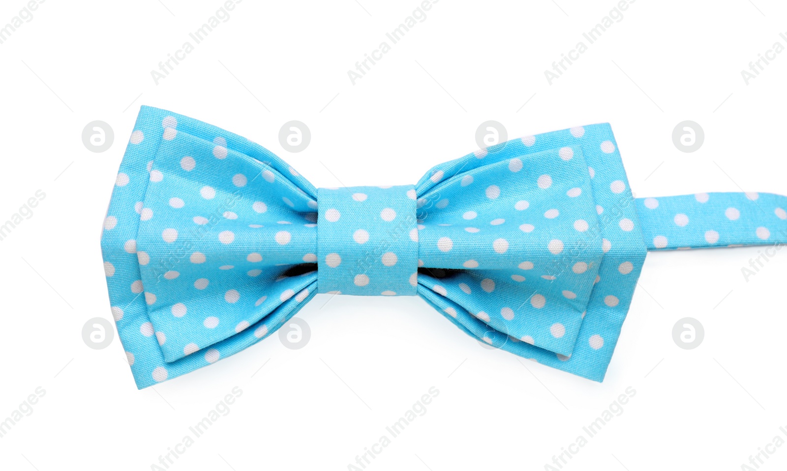 Photo of Stylish light blue bow tie with polka dot pattern on white background, top view