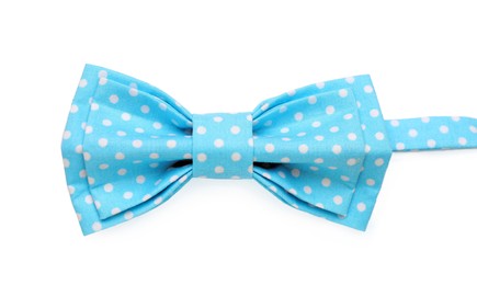 Stylish light blue bow tie with polka dot pattern on white background, top view