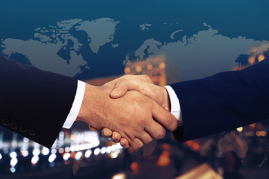 Image of Multiple exposure of partners shaking hands, world map and night city. Business values