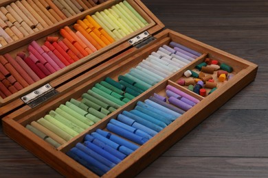 Drawing pastel set in box on wooden table, closeup