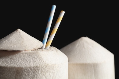 Photo of Fresh coconut drink in nut on black background