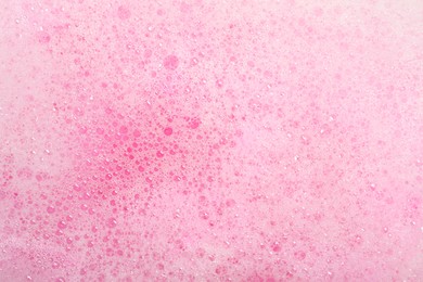 Colorful foam after dissolving bath bomb in water, closeup