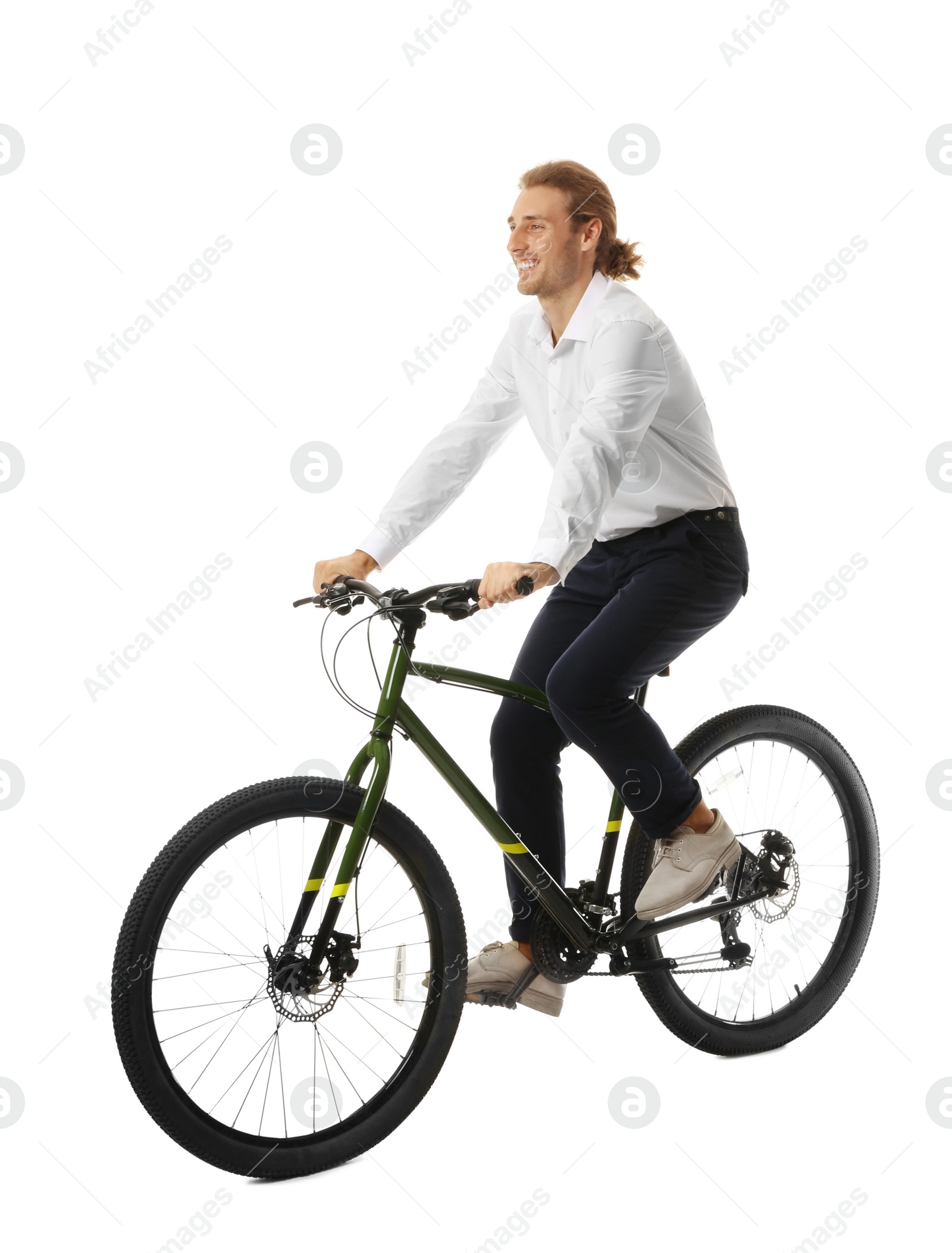 Photo of Happy young man riding bicycle on white background