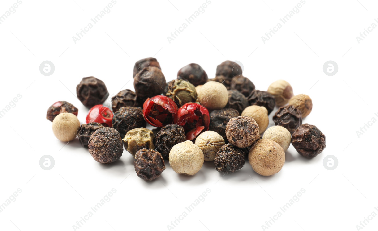 Photo of Aromatic spices. Pile of different peppers isolated on white