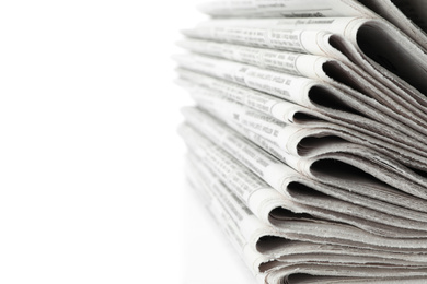 Stack of newspapers on white background, closeup. Journalist's work