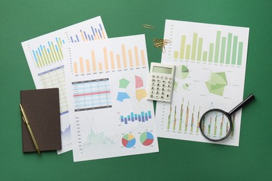 Photo of Accounting documents, magnifying glass, calculator and stationery on green background, flat lay