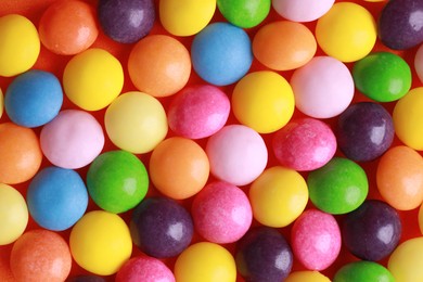 Photo of Many delicious colorful dragee candies, above view