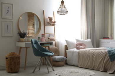 Photo of Teenage girl's bedroom interior with stylish furniture. Idea for design