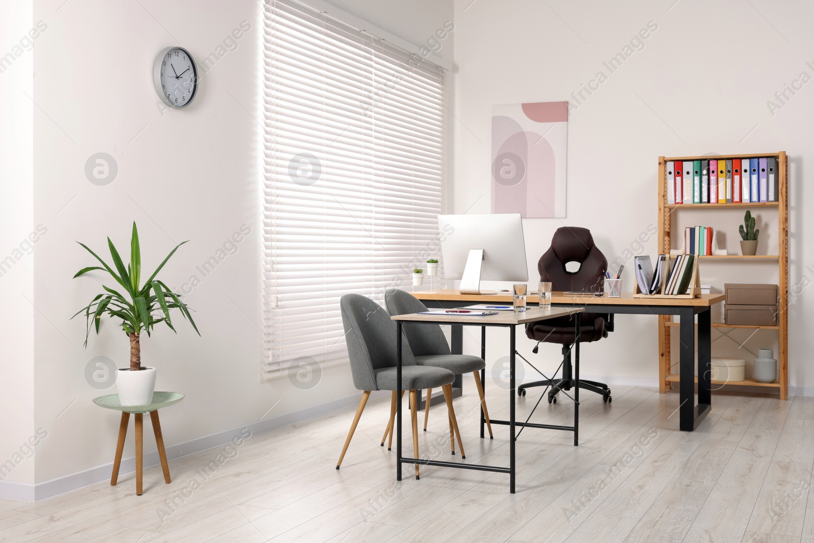 Photo of Director's office with large wooden table and comfortable armchairs. Interior design