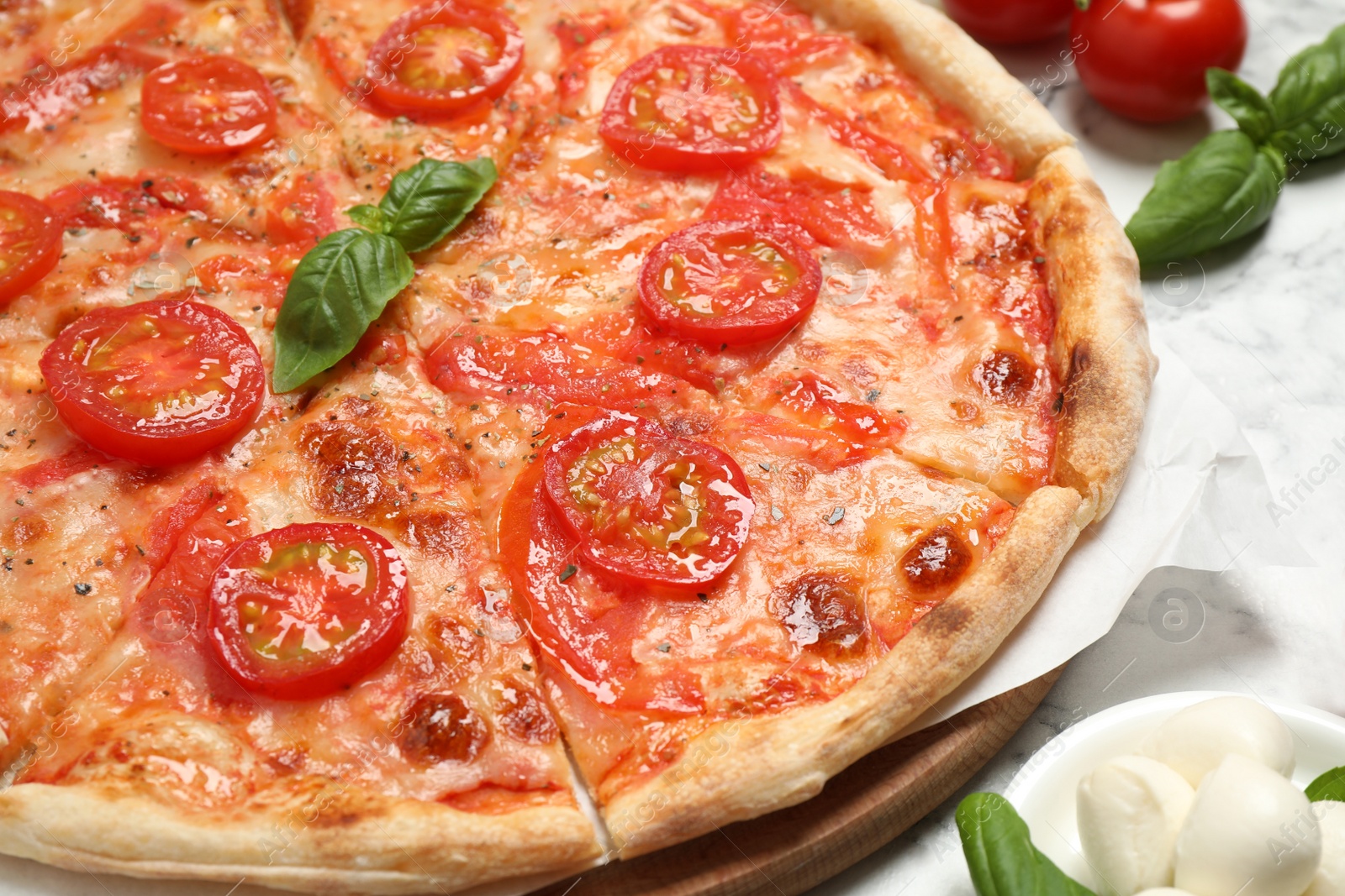 Photo of Delicious pizza Margherita on white marble table, closeup