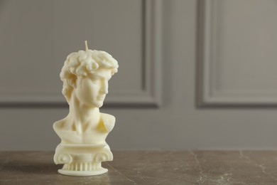 Photo of Beautiful David bust candle on grey table. Space for text