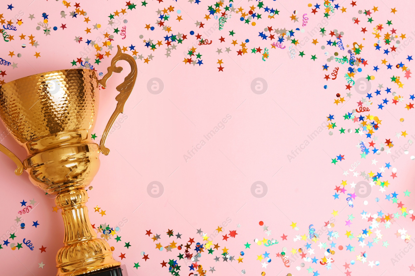 Photo of Trophy and frame of confetti on color background, top view with space for text. Victory concept