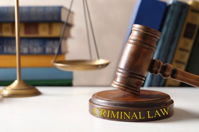 Image of Wooden gavel, scales of justice and books on table. Criminal law concept