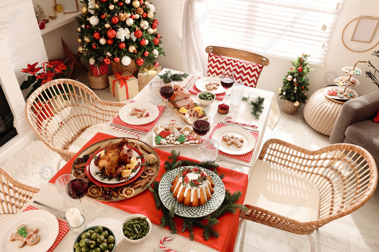 Photo of Festive dinner with delicious food and wine on table indoors, above view. Christmas Eve celebration