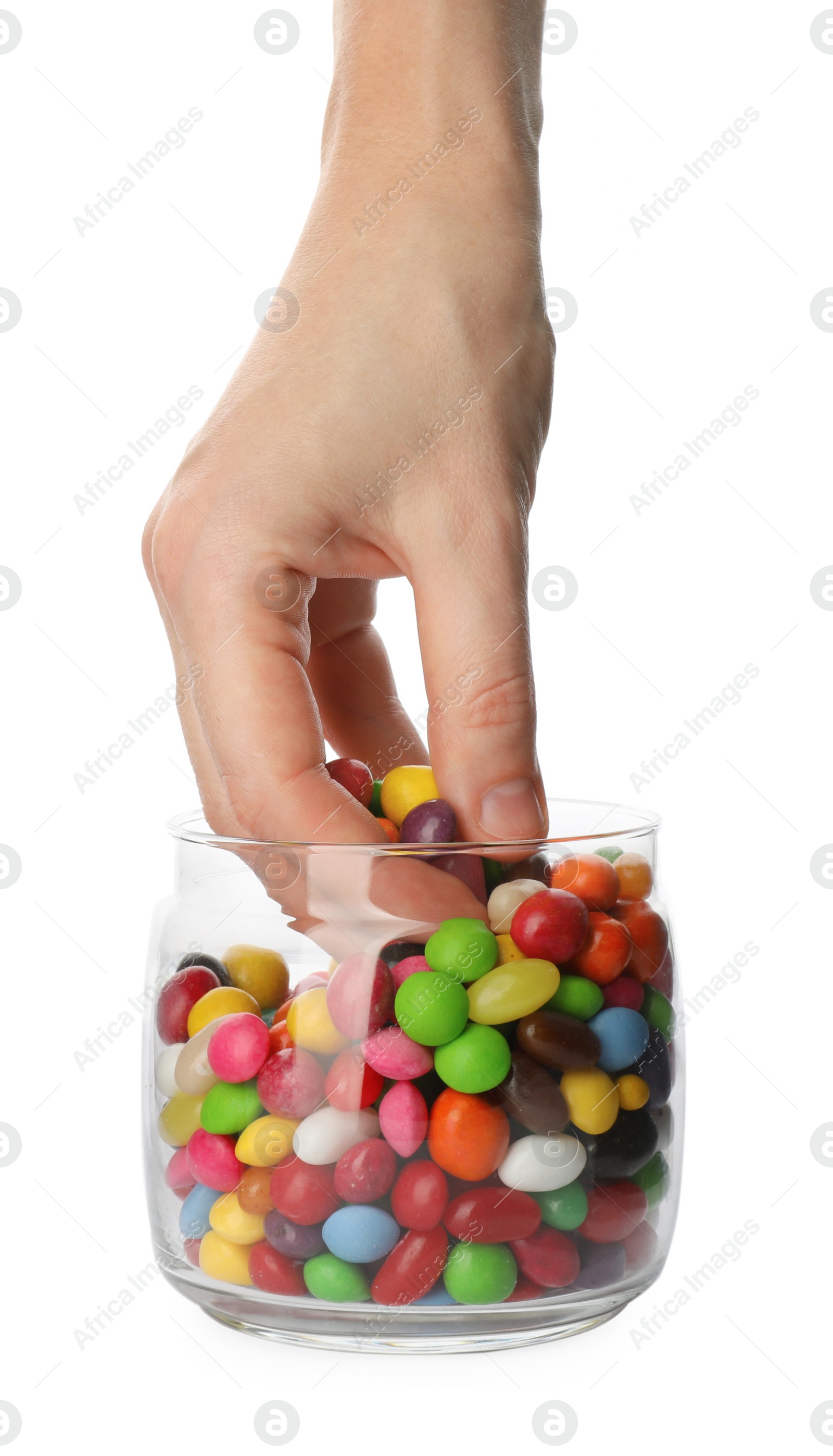Photo of Woman taking candies from glass jar on white background, closeup