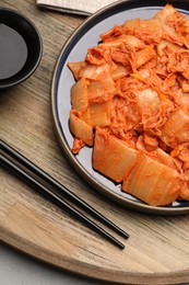 Photo of Delicious kimchi with Chinese cabbage and sauce on white table, top view