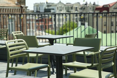 Photo of Observation area cafe. Tables and chairs on terrace against beautiful cityscape