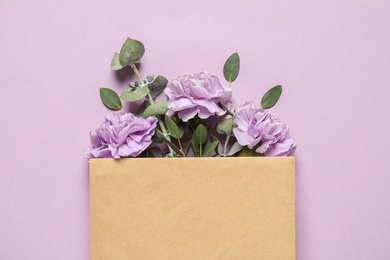 Photo of Flat lay composition with beautiful blooming flowers on color background