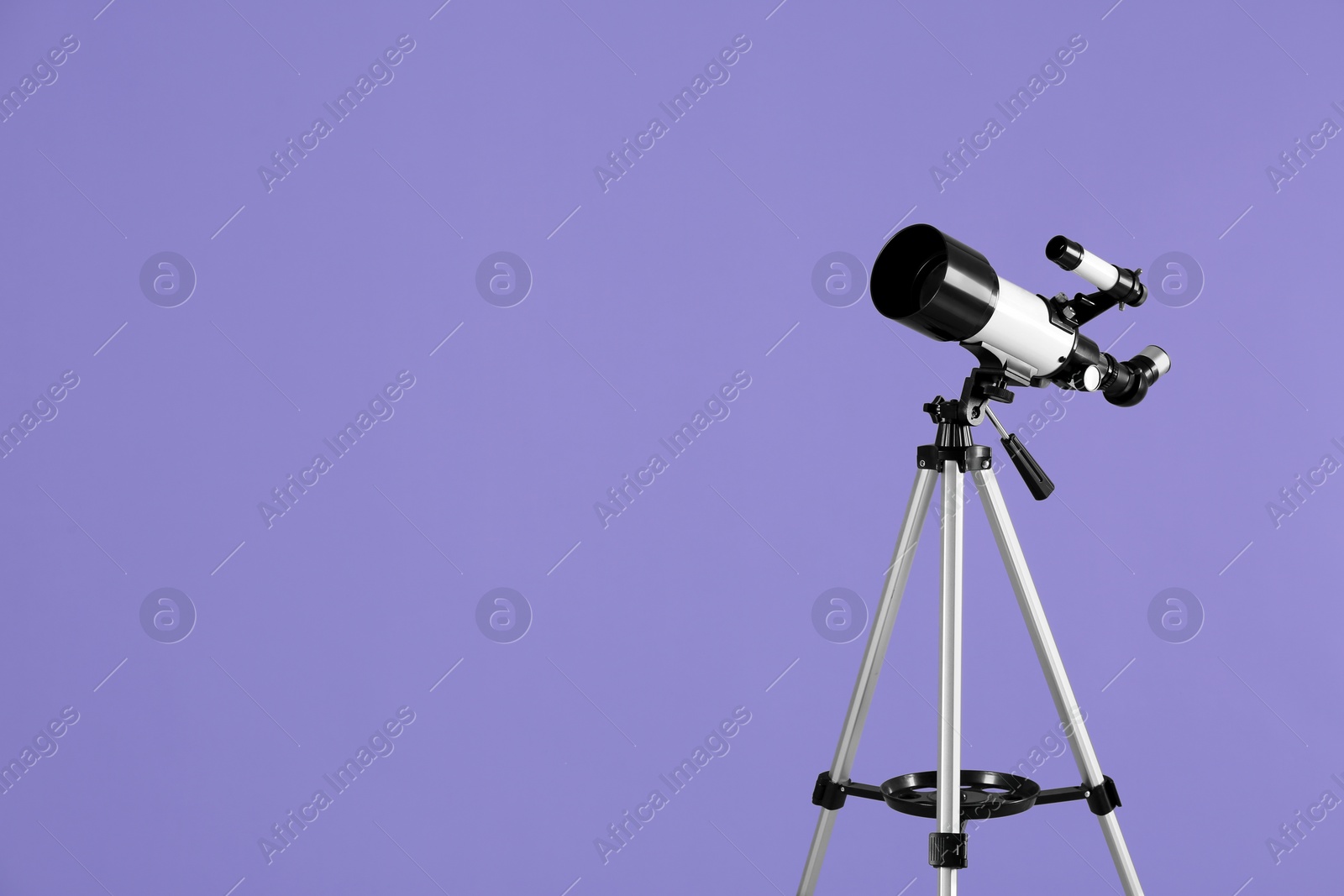 Photo of Tripod with modern telescope on light purple background, space for text