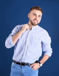 Photo of Portrait of handsome happy man on color background